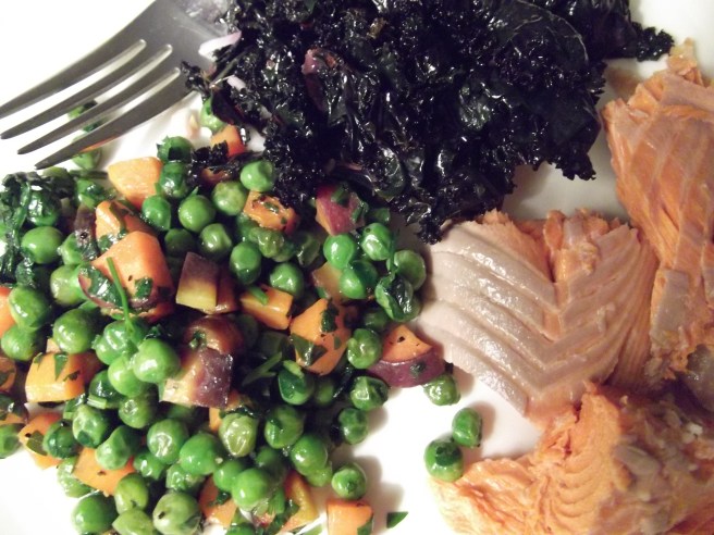 Buttery, herby peas and carrots with salmon and kale.