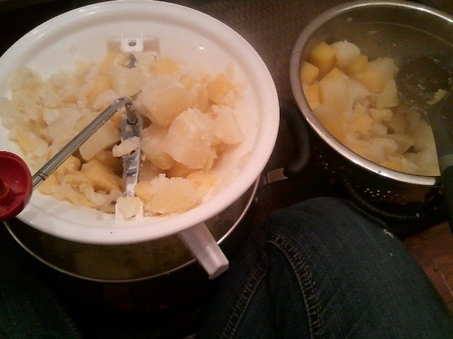 Sitting on the floor, milling some turnips and potatoes.